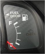 Arrow pointing to side of truck with gas cap.